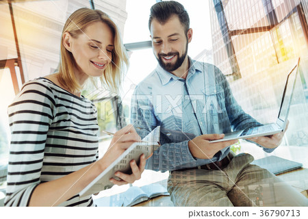 Pleasant interested office workers smiling and 36790713