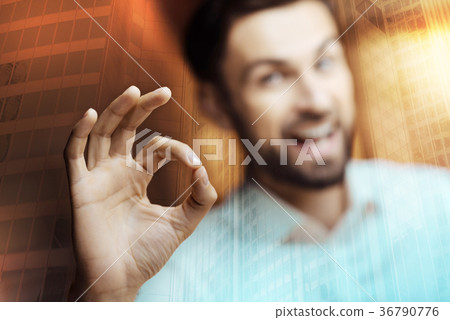 Smiling young man showing OK gesture 36790776
