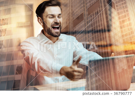 Happy man showing thumbs up while having video Happy man showing thumbs up while having video 36790777