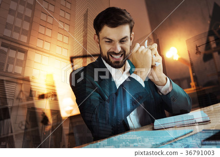 Young businessman tearing papers in anger Young businessman tearing papers in anger 36791003