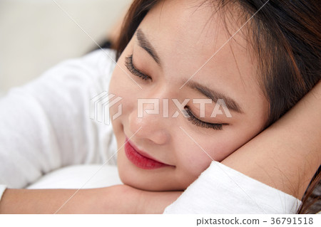 A twenties woman enjoying a happy day in bed A twenties woman enjoying a happy day in bed 36791518