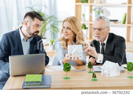 Concentrated realtors discussing the price of a 36792292