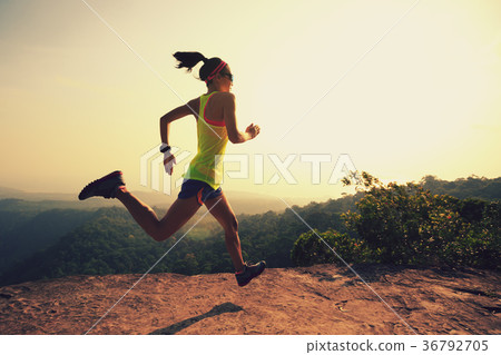 Young  woman trail runner running at mountain top 36792705