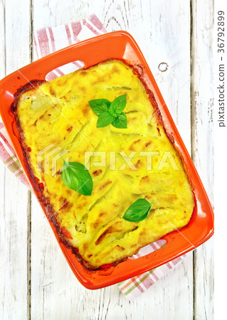 Gratin potato with fish in brazier on board top Gratin potato with fish in brazier on board top 36792899