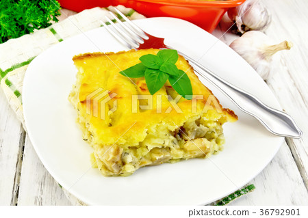 Gratin potato with fish in plate on board Gratin potato with fish in plate on board 36792901