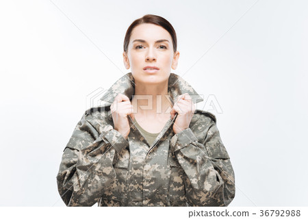 Young earnest woman placing her collar 36792988