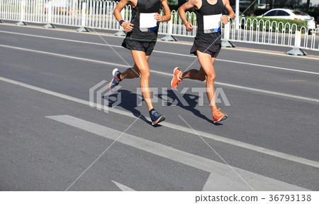 Marathon runners running on city road 36793138