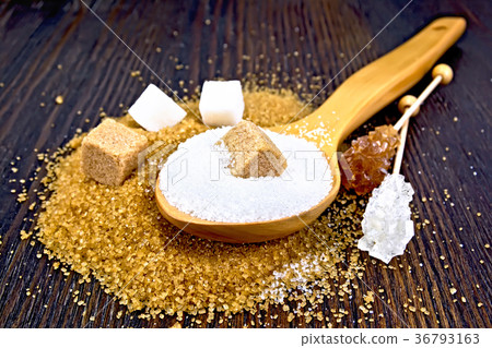 Sugar white and brown in spoon on dark board 36793163