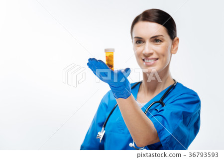 Joyful  female laboritorian proposing pills 36793593