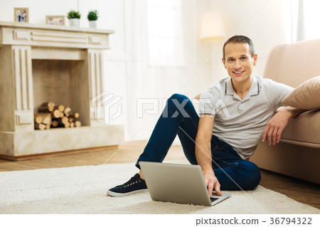 Happy working man smiling while sitting on the 36794322