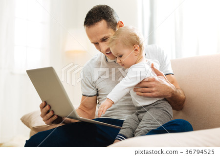Kind positive father sitting with his child and Kind positive father sitting with his child and 36794525