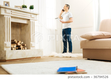 Positive emotional man talking on the phone while Positive emotional man talking on the phone while 36794526