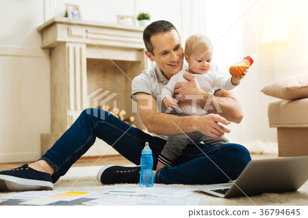 Happy father pointing to the screen while his Happy father pointing to the screen while his 36794645