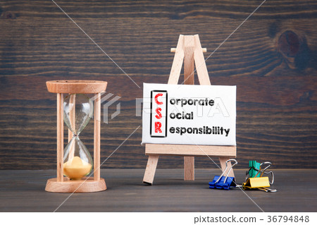 Corporate Social Responsibility. Sandglass, hourglass or egg timer on wooden table Corporate Social Responsibility. Sandglass, hourglass or egg timer on wooden table 36794848