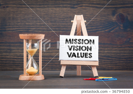 Mission, Vision and Values. Sandglass, hourglass or egg timer on wooden table Mission, Vision and Values. Sandglass, hourglass or egg timer on wooden table 36794850
