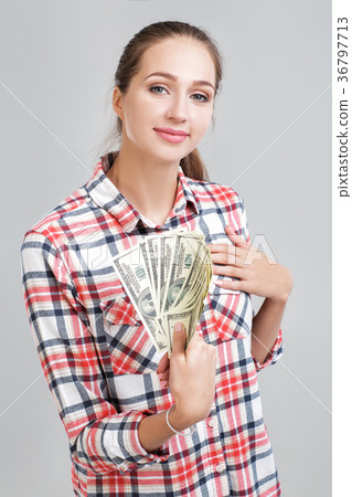 woman in a plaid shirt holding dollar bills 36797713
