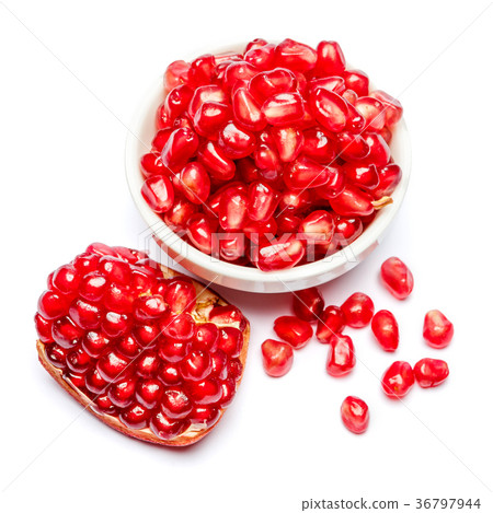 Pomegranate and seeds in ceramic bowl close-up Pomegranate and seeds in ceramic bowl close-up 36797944