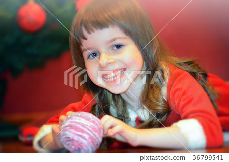 Little girl in Santa's dress with Christmas ball Little girl in Santa's dress with Christmas ball 36799541