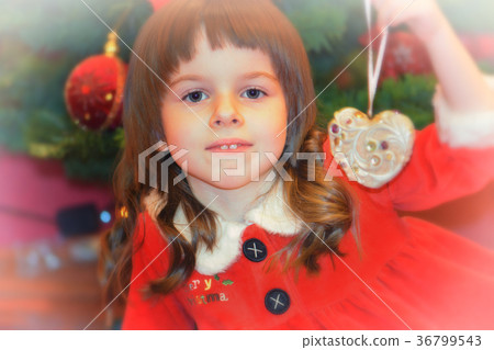 Little girl in Santa's dress with xmas decoration Little girl in Santa's dress with xmas decoration 36799543