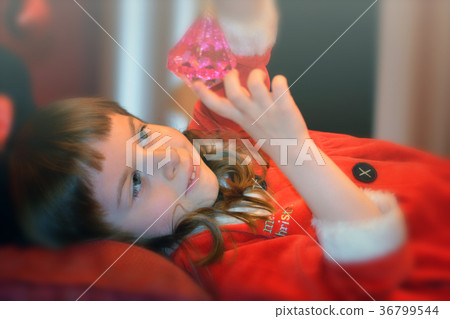 Little girl in Santa's dress with magical crystal Little girl in Santa's dress with magical crystal 36799544