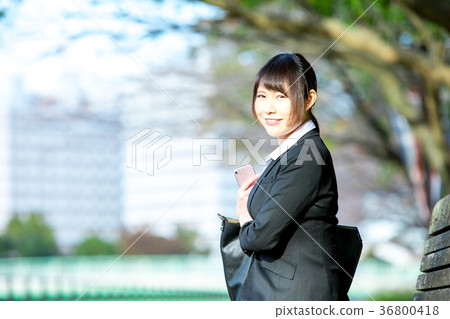 在衣服的婦女OL西裝與智能手機畫象Recruit綠色背景 在衣服的婦女OL西裝與智能手機畫象Recruit綠色背景 36800418