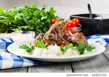 Barbecued kofta with rice on a plate 36802320