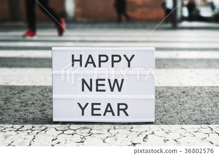 text happy new year in a lightbox on the asphalt 36802576