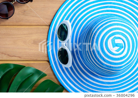 top view blue hat and sunglasses on a wooden table top view blue hat and sunglasses on a wooden table 36804296