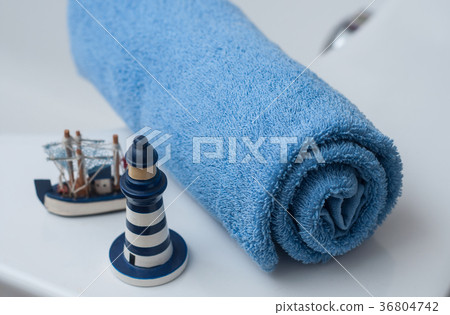 blue rolled bath towel with ocean decoration  36804742