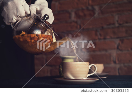 Pouring tea with sea buckthorn 36805355