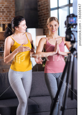 圖庫照片: joyful nice women exercising in front of the