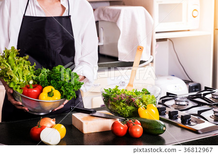 Healthy Woman makes fresh vegetable salad with olive oil, tomato Healthy Woman makes fresh vegetable salad with olive oil, tomato 36812967