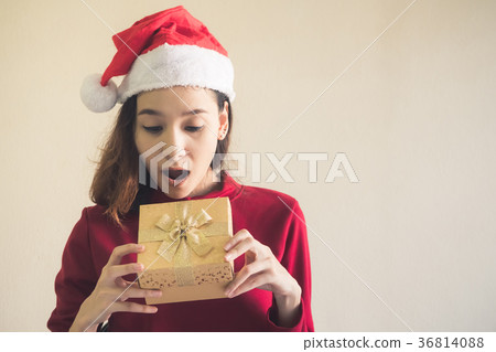 Happy Asian woman holding gift box. 36814088