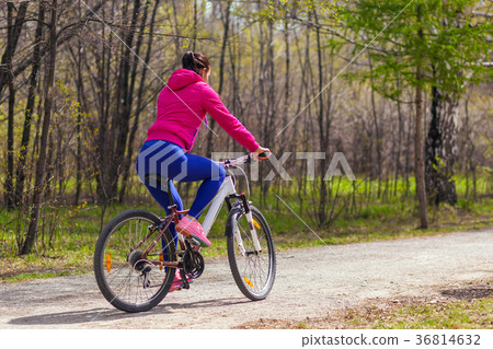 woman jeans rides a bike woman jeans rides a bike 36814632