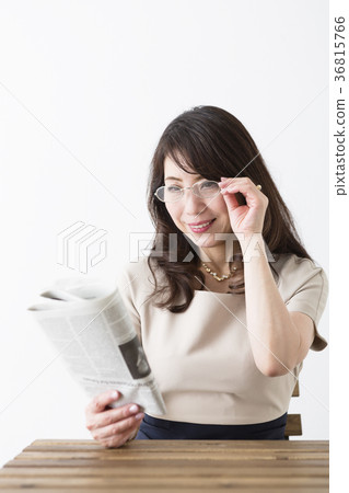 Middle female reading newspaper 36815766