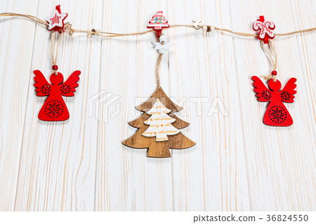 Christmas wooden toys are hung on a rope  36824550