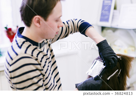 the hairdresser in the salon makes hair coloring the hairdresser in the salon makes hair coloring 36824813
