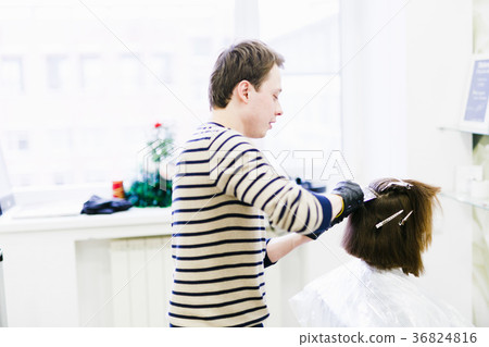 the hairdresser in the salon makes hair coloring the hairdresser in the salon makes hair coloring 36824816