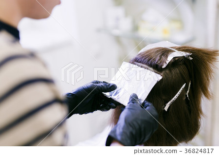 the hairdresser in the salon makes hair coloring the hairdresser in the salon makes hair coloring 36824817