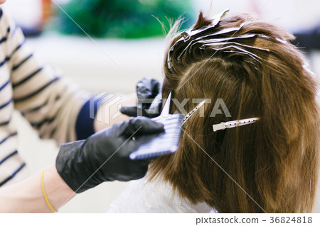 the hairdresser in the salon makes hair coloring the hairdresser in the salon makes hair coloring 36824818