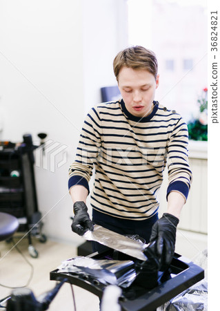the hairdresser in the salon makes hair coloring the hairdresser in the salon makes hair coloring 36824821