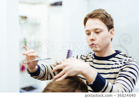 hairdresser in the beauty salon does a haircut hairdresser in the beauty salon does a haircut 36824840