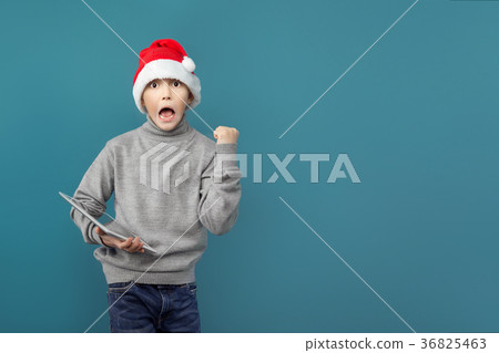 Cute boy celebrating with tablet 36825463