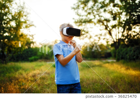 Fascinated little boy using VR virtual reality Fascinated little boy using VR virtual reality 36825470