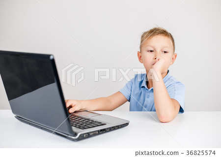 Pensive kid at laptop Pensive kid at laptop 36825574