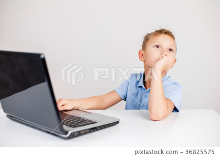 Pensive kid at laptop 36825575