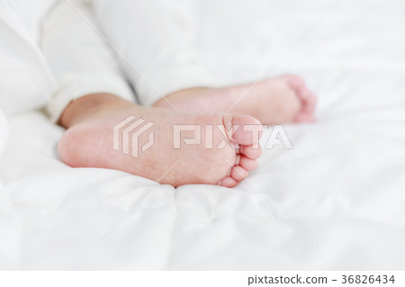 little baby feet on bed 36826434