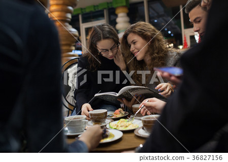 Group of teenagers doing homework in cafe. Group of teenagers doing homework in cafe. 36827156