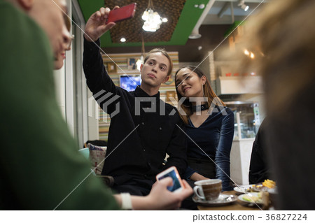Group of positive teenagers make selfies and 36827224
