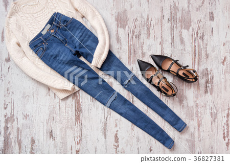 Blue ragged jeans, sweater and black shoes Blue ragged jeans, sweater and black shoes 36827381
